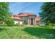 Stately brick home with a manicured lawn and lush landscaping in a desirable neighborhood at 8904 Woodhall Lake Dr, Waxhaw, NC 28173
