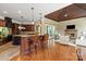 Open kitchen with a granite island, breakfast bar, fireplace, and adjacent living area at 8904 Woodhall Lake Dr, Waxhaw, NC 28173