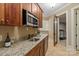 Basement kitchenette includes a sink, microwave, and a doorway to the workout room at 8904 Woodhall Lake Dr, Waxhaw, NC 28173
