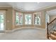 Spacious living room with backyard views through the series of windows at 8904 Woodhall Lake Dr, Waxhaw, NC 28173