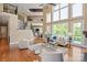 Bright living room with soaring windows, hardwood floors, and an open staircase at 8904 Woodhall Lake Dr, Waxhaw, NC 28173