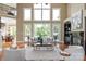 Sophisticated living room featuring large windows, a cozy fireplace, and stylish decor at 8904 Woodhall Lake Dr, Waxhaw, NC 28173