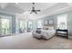 Spacious main bedroom with large windows, sitting area, and a tray ceiling at 8904 Woodhall Lake Dr, Waxhaw, NC 28173