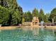 Backyard pool includes an outdoor fireplace and lounge chairs for relaxing at 8904 Woodhall Lake Dr, Waxhaw, NC 28173