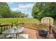 Backyard deck with a seating arrangement and view of the lawn, trees, and storage shed at 11701 Brockley Ct, Charlotte, NC 28215