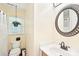 Well-lit bathroom features a vanity with a sink, a toilet, and a hanging plant at 11701 Brockley Ct, Charlotte, NC 28215
