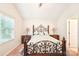 Cozy bedroom with decorative iron bed frame, side tables, and a bright window at 11701 Brockley Ct, Charlotte, NC 28215