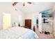 Bright bedroom with ceiling fan, television, and entry to attached bathroom at 11701 Brockley Ct, Charlotte, NC 28215