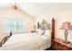 Comfortable bedroom featuring a decorative iron bed frame with bedside tables and lamps at 11701 Brockley Ct, Charlotte, NC 28215
