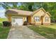 Charming yellow home with attached garage, brick accents, and well-maintained landscaping at 11701 Brockley Ct, Charlotte, NC 28215