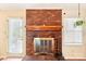 Close-up of a brick fireplace with a wooden mantel, adding warmth to the home at 11701 Brockley Ct, Charlotte, NC 28215