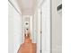 Hallway featuring wood floors, closet space, and access to the bathroom at 11701 Brockley Ct, Charlotte, NC 28215