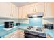 Well-lit kitchen features bright countertops, appliances, and classic cabinetry at 11701 Brockley Ct, Charlotte, NC 28215