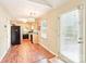 Open kitchen layout with wood floors, a kitchen window, and an adjacent back door at 11701 Brockley Ct, Charlotte, NC 28215