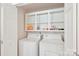 Laundry room with washer, dryer, and shelving for optimal storage at 11701 Brockley Ct, Charlotte, NC 28215