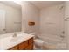 Neutral bathroom featuring a wooden vanity and a shower-tub combination at 118 Barnhardt Loop, Mooresville, NC 28117