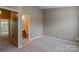 Spacious carpeted bedroom with a view of the en-suite bathroom at 118 Barnhardt Loop, Mooresville, NC 28117
