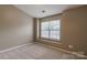 Well-lit bedroom with a large window providing natural light at 118 Barnhardt Loop, Mooresville, NC 28117