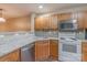 Corner view of kitchen featuring granite countertops, wood cabinets, and stainless steel appliances at 118 Barnhardt Loop, Mooresville, NC 28117