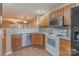 Open kitchen with granite countertops, stainless steel dishwasher, and wood cabinets at 118 Barnhardt Loop, Mooresville, NC 28117