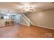 Spacious living room featuring wood-look flooring, access to the kitchen and a staircase to the upper level at 118 Barnhardt Loop, Mooresville, NC 28117