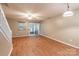 Open-concept living room with wood-look flooring and sliding door access to the back patio at 118 Barnhardt Loop, Mooresville, NC 28117