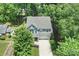 Aerial view showcases the home's roof, surrounding trees, and long driveway at 1209 Leigh Ave, Charlotte, NC 28205