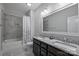 Bathroom featuring a shower/tub combo, dual sinks, and granite countertops at 1209 Leigh Ave, Charlotte, NC 28205