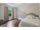 Stylish bedroom with wood floors, natural light, and fun accent wall at 1209 Leigh Ave, Charlotte, NC 28205