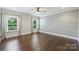 Large bedroom with hardwood floors, neutral walls, and views of the outside at 1209 Leigh Ave, Charlotte, NC 28205
