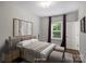 Bedroom with ample natural light, hardwood floors, and modern decor at 1209 Leigh Ave, Charlotte, NC 28205