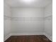 Walk-in closet with wood floor, white walls, and wire shelving for maximum storage at 1209 Leigh Ave, Charlotte, NC 28205