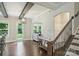 Inviting entryway with hardwood floors, striking ceiling beams, and access to a private backyard at 1209 Leigh Ave, Charlotte, NC 28205