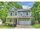 Charming two-story home features a blue front door, grey siding, and a well-maintained lawn at 1209 Leigh Ave, Charlotte, NC 28205