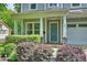 Inviting front door with stone accents, surrounded by lush landscaping, adding curb appeal at 1209 Leigh Ave, Charlotte, NC 28205