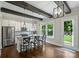 Bright kitchen featuring a center island with bar seating, stainless appliances, and a view of the backyard at 1209 Leigh Ave, Charlotte, NC 28205