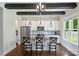 Charming kitchen featuring white cabinets, granite countertops, stainless steel appliances, and a wooden beamed ceiling at 1209 Leigh Ave, Charlotte, NC 28205