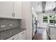 Well-lit kitchen with granite countertops, stainless steel appliances, and shaker style cabinets at 1209 Leigh Ave, Charlotte, NC 28205