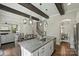 Gourmet kitchen island with seating and stainless dishwasher, overlooking a cozy living room and fireplace at 1209 Leigh Ave, Charlotte, NC 28205
