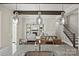 Open concept kitchen island with sink looking into an adjoining living area with fireplace and staircase at 1209 Leigh Ave, Charlotte, NC 28205