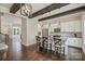 Open concept living area showcasing hardwood floors, exposed beams, kitchen and view to an additional living space at 1209 Leigh Ave, Charlotte, NC 28205