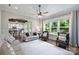 Bright living room with hardwood floors, neutral walls, ceiling fan, and view to kitchen and backyard at 1209 Leigh Ave, Charlotte, NC 28205