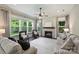 Well-lit living room featuring many windows and a charming fireplace, creating a cozy atmosphere at 1209 Leigh Ave, Charlotte, NC 28205