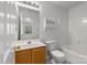 Bathroom featuring a vanity, mirror, toilet, tub with tiled shower and shelving unit at 13660 Meade Glen Ct, Charlotte, NC 28273