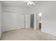 Carpeted bedroom featuring multiple closets, ceiling fan and a door to the ensuite bath at 13660 Meade Glen Ct, Charlotte, NC 28273