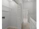 Hallway with laundry closet and view of carpeted bedrooms at 13660 Meade Glen Ct, Charlotte, NC 28273