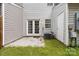 Back patio featuring double doors leading into the home and the AC unit in the corner at 13660 Meade Glen Ct, Charlotte, NC 28273