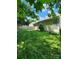 Well-maintained backyard with lush green grass, a wooden fence, and mature trees at 14343 Arbor Ridge Dr, Charlotte, NC 28273