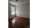 Bright bedroom featuring hardwood floors and a window offering ample natural light at 14343 Arbor Ridge Dr, Charlotte, NC 28273