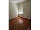 Bedroom with hardwood floors, neutral walls, and a bright window at 14343 Arbor Ridge Dr, Charlotte, NC 28273